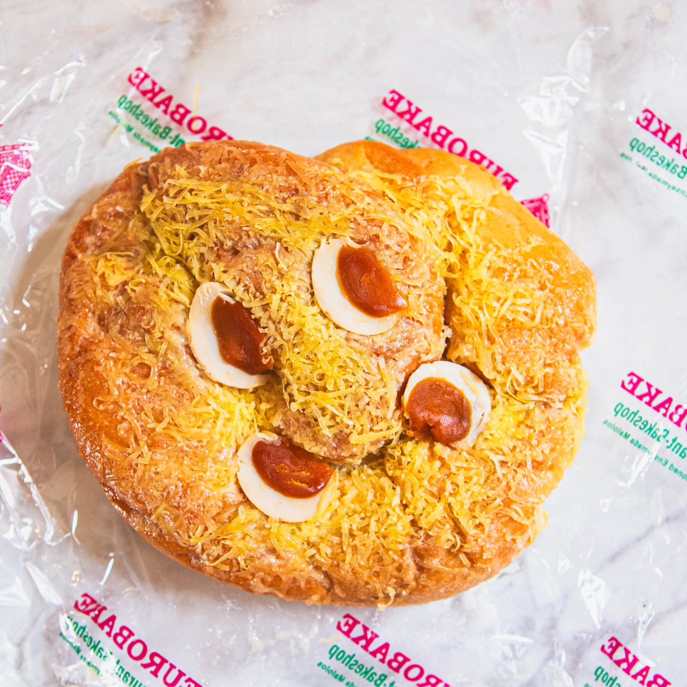 nsaymada, a pillowy brioche slathered with butter and topped with salted egg and heaps of cheese shavings
