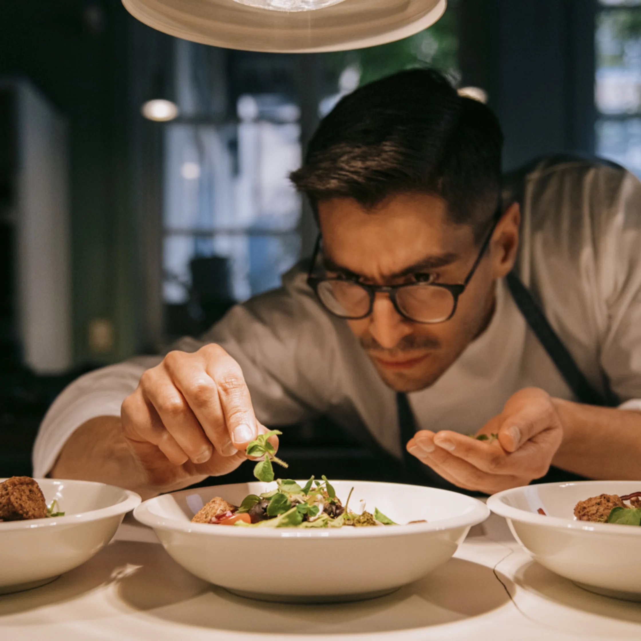 chef palting food with precision