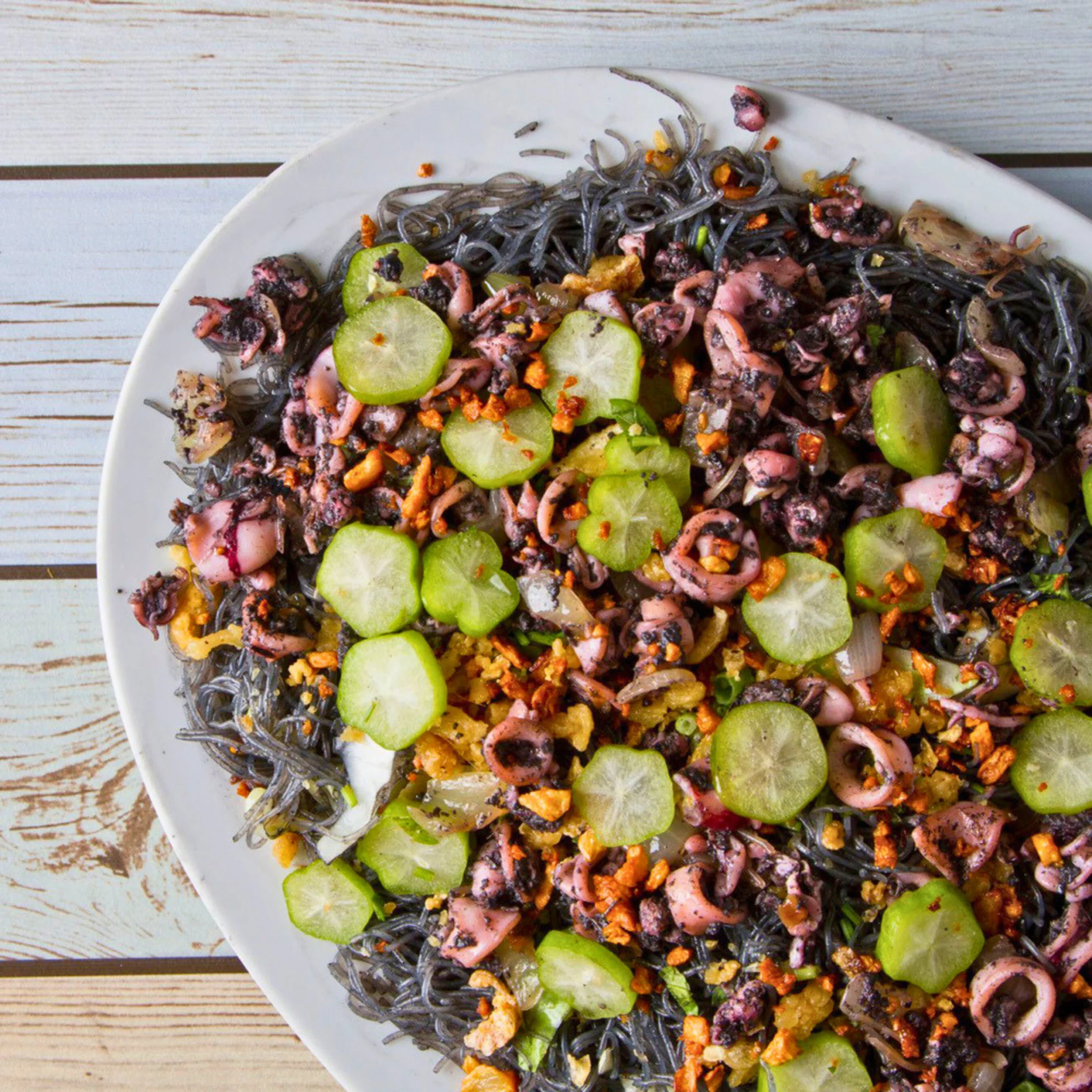 Pancit Pusit pancit with squid ink and seafood topppngs