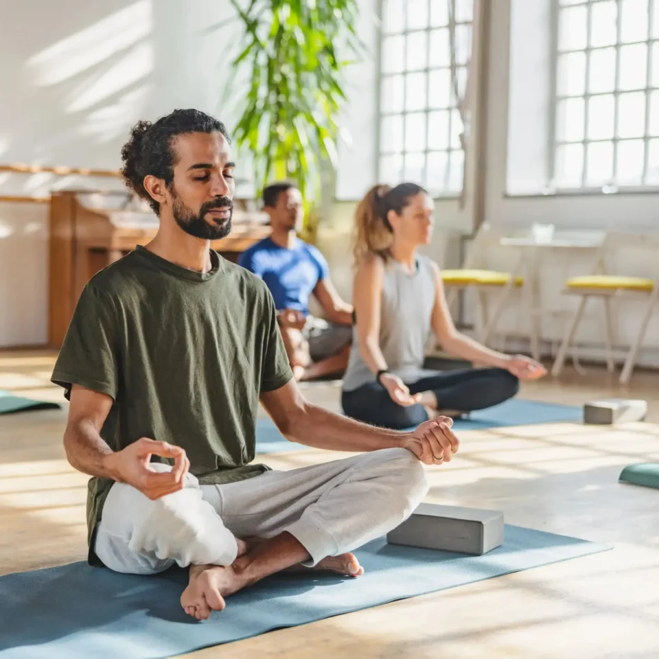 Man in yoga pose practicing meditation