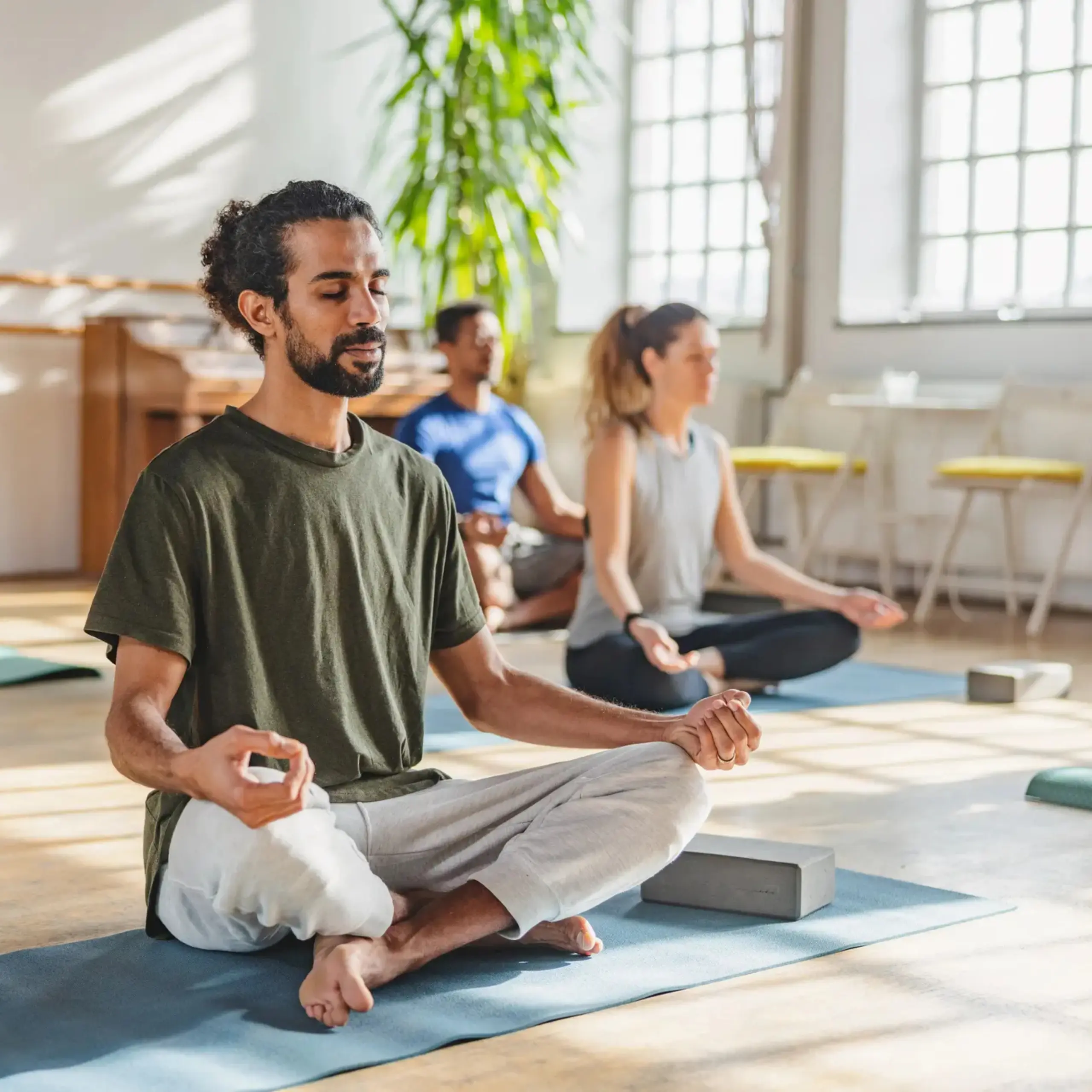 Man in yoga pose practicing meditation