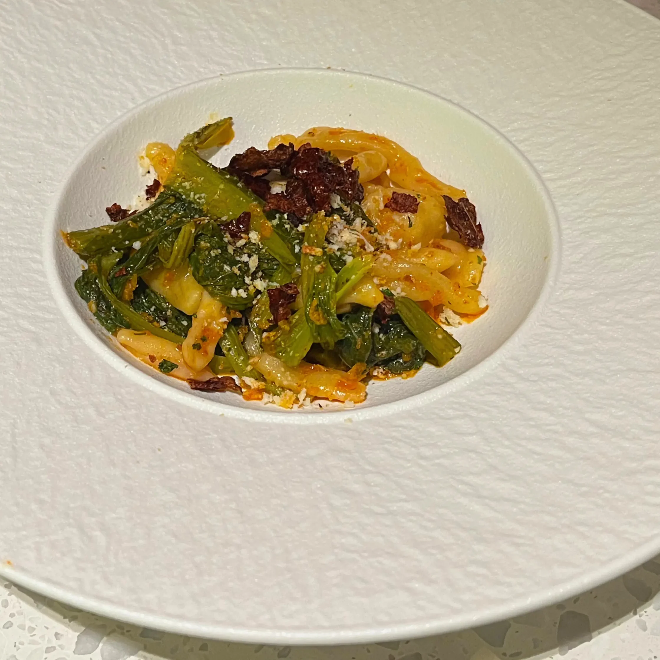 Trittico Lucano with Fermented Mustasa and Peperone Crusco in a deep, wide, white plate