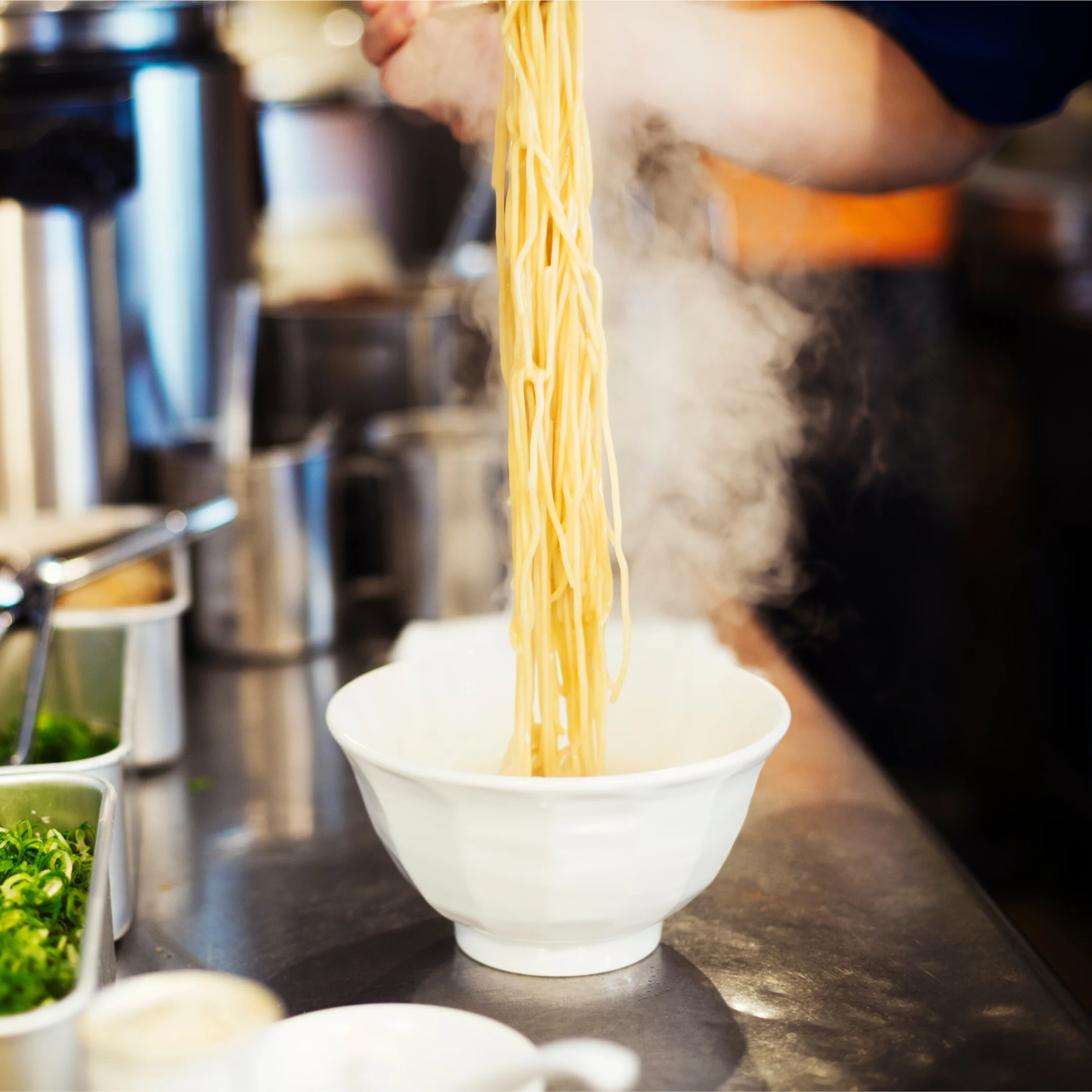 freshly cooked ramen noodles still steaming being served