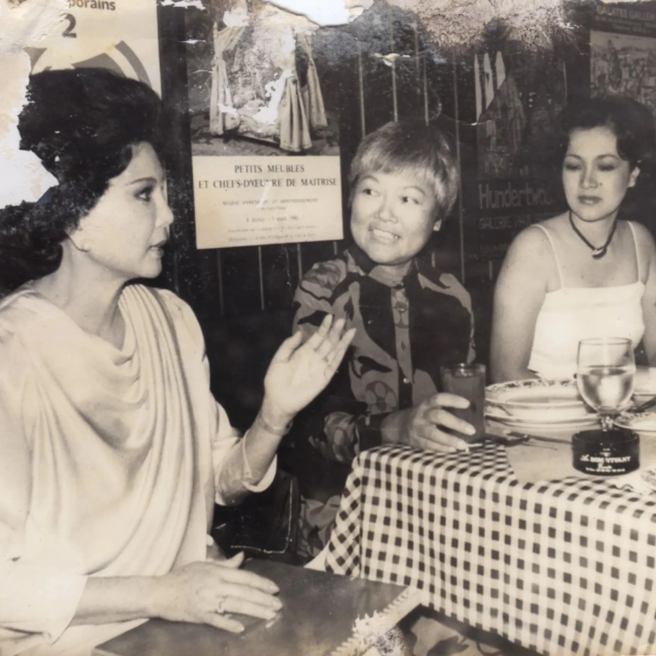 Black and white photo of three women in conversation