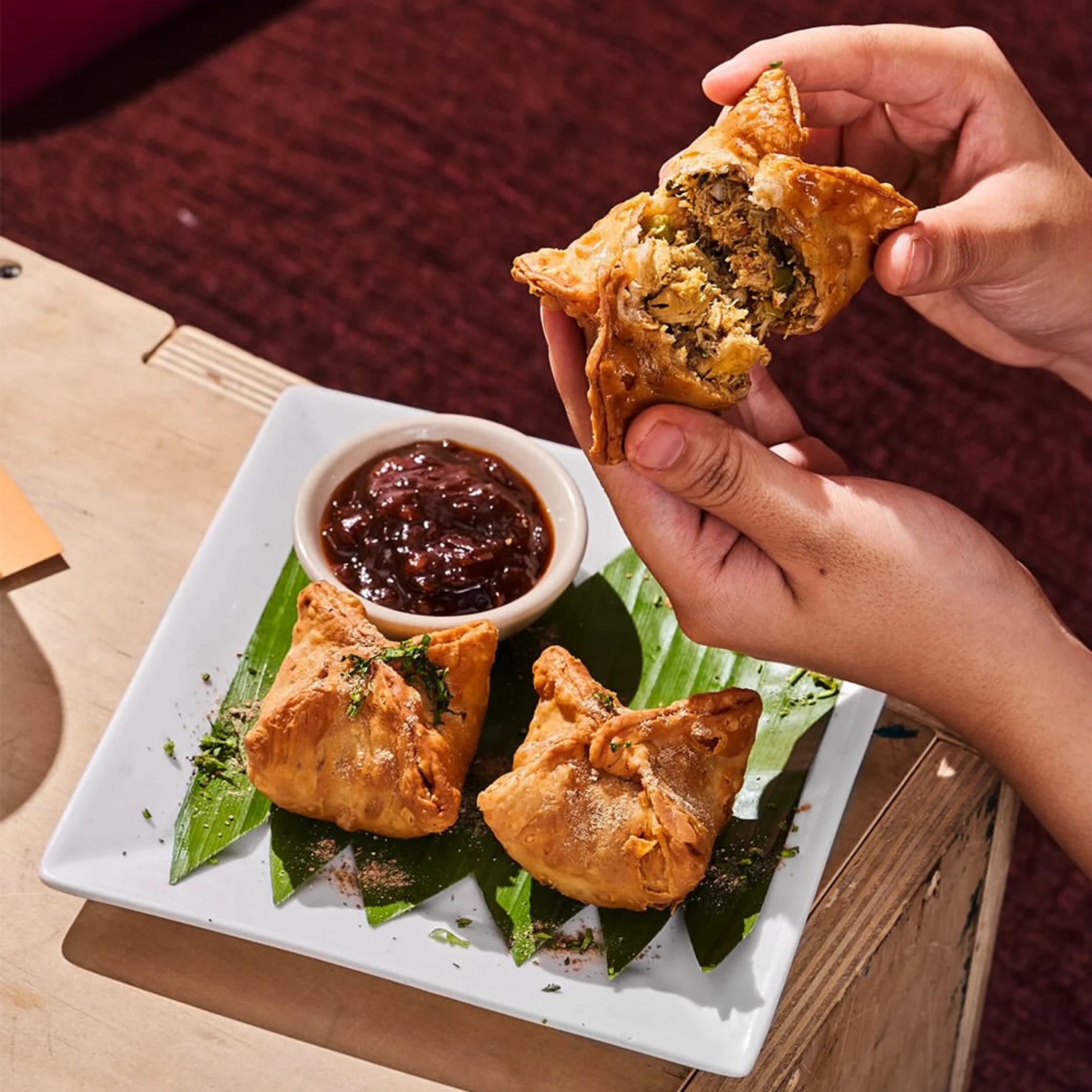 samosa from 50-year old kasmir in makati being broken open to reveal savory filling