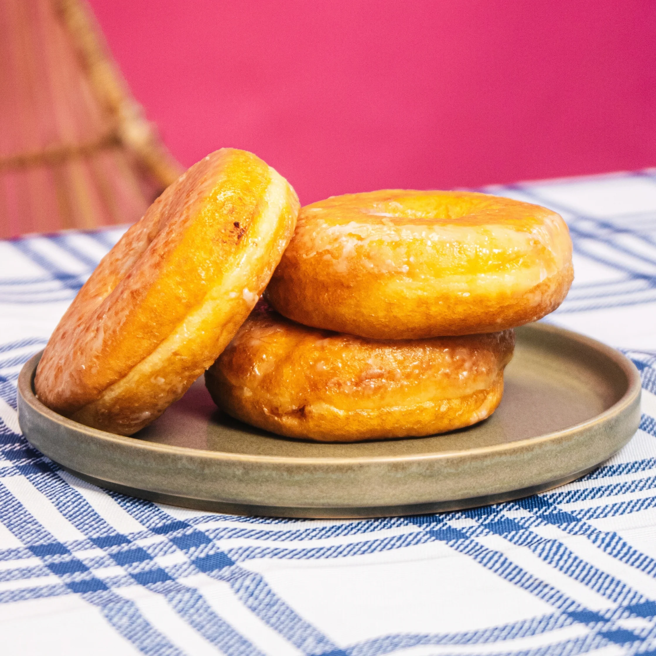 three pieces of donut stacked on a brown plate