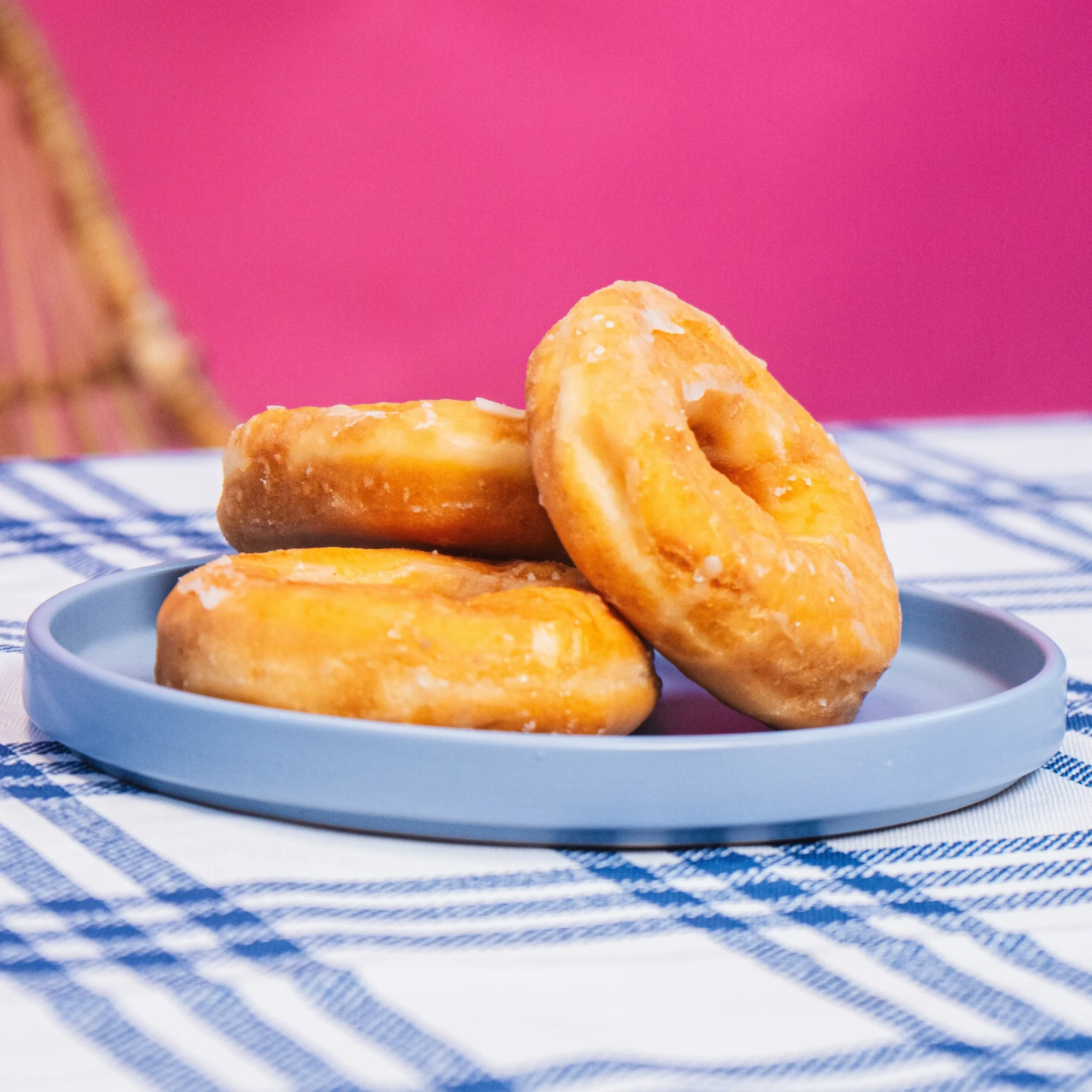 three pieces of donut stacked on a blue plate