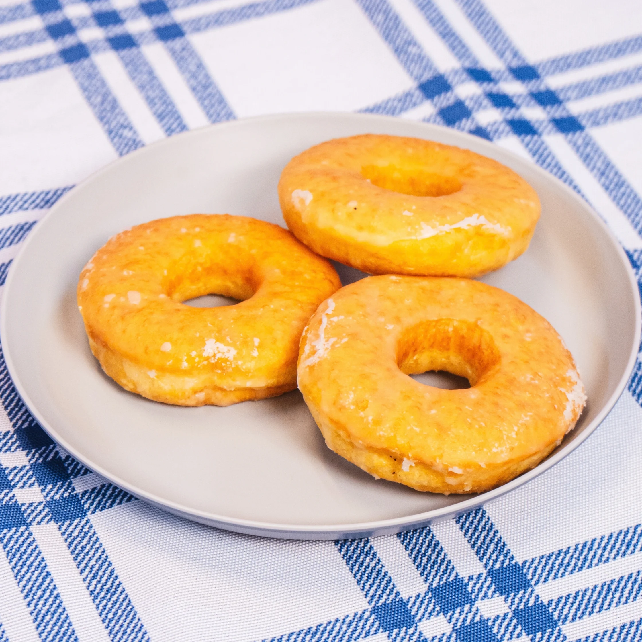 three pieces of donut stacked on a grey plate