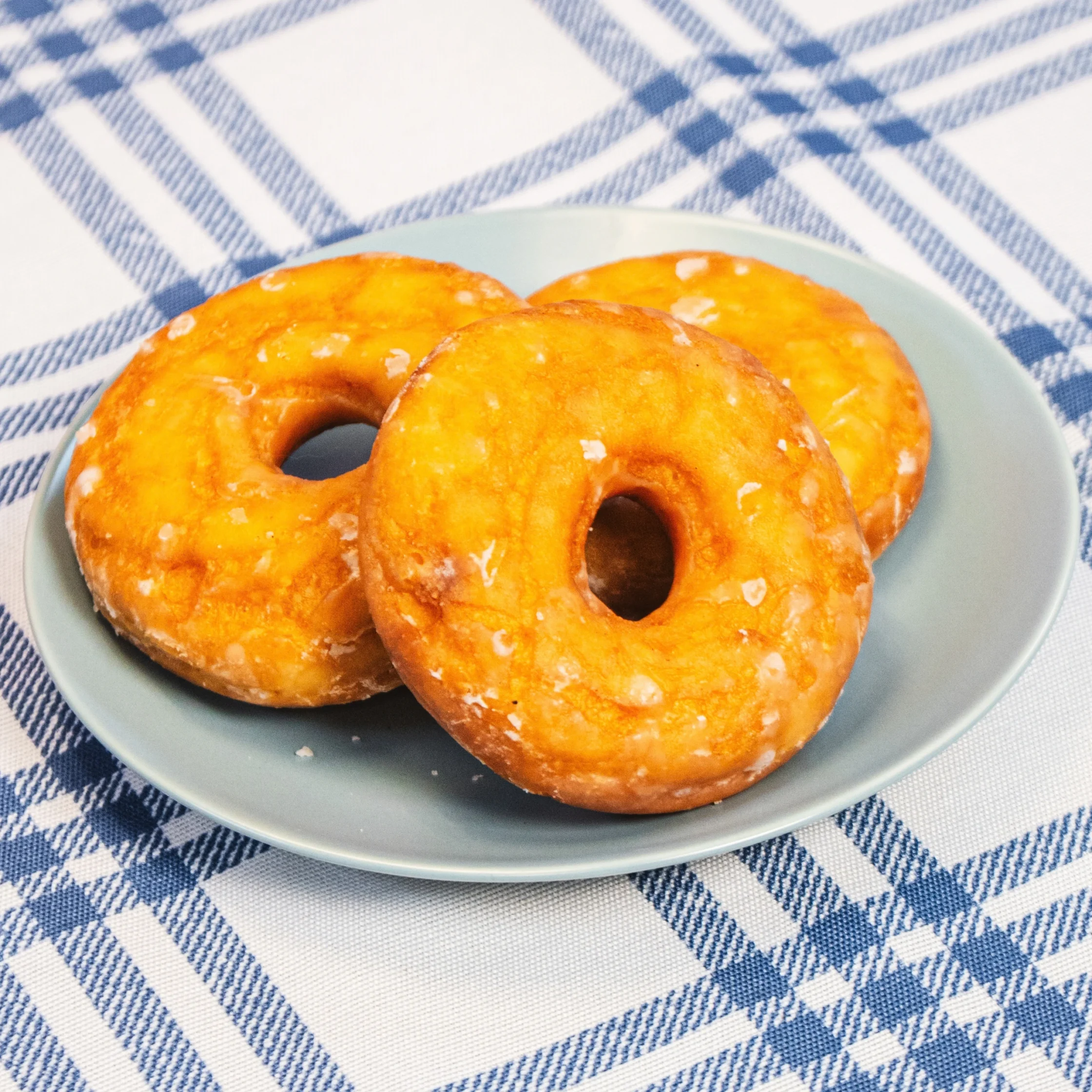 three pieces of donut stacked on a light blue plate